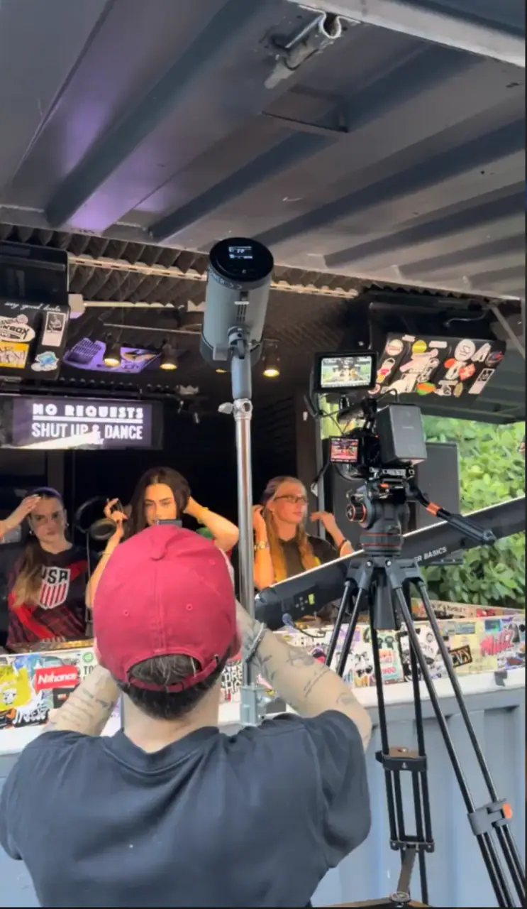 Behind the scenes — match-day capture at a sticker-covered booth with a USA soccer jersey.