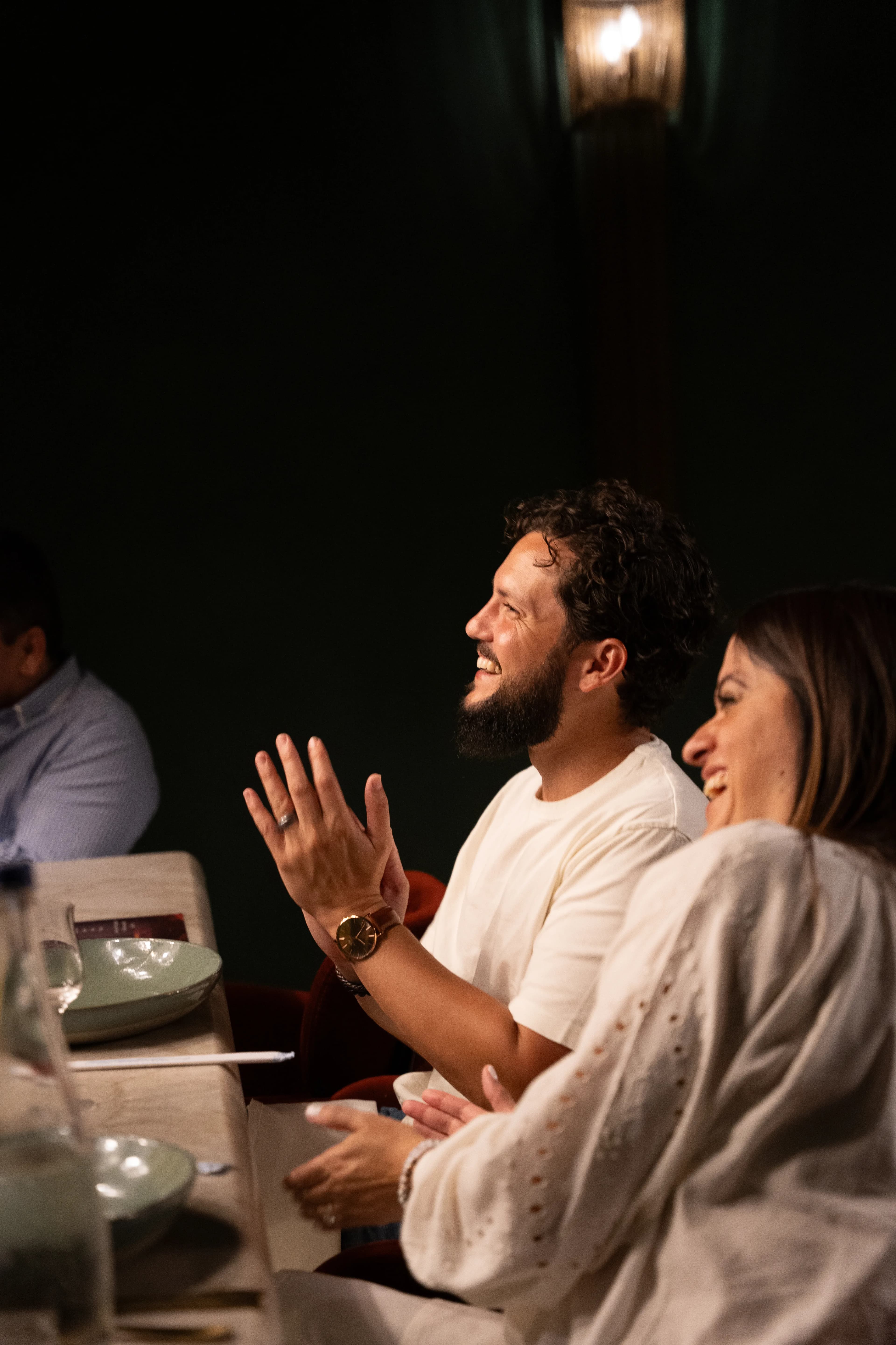 Guests share a candlelit meal in the dim dining room at Sushi Sake.