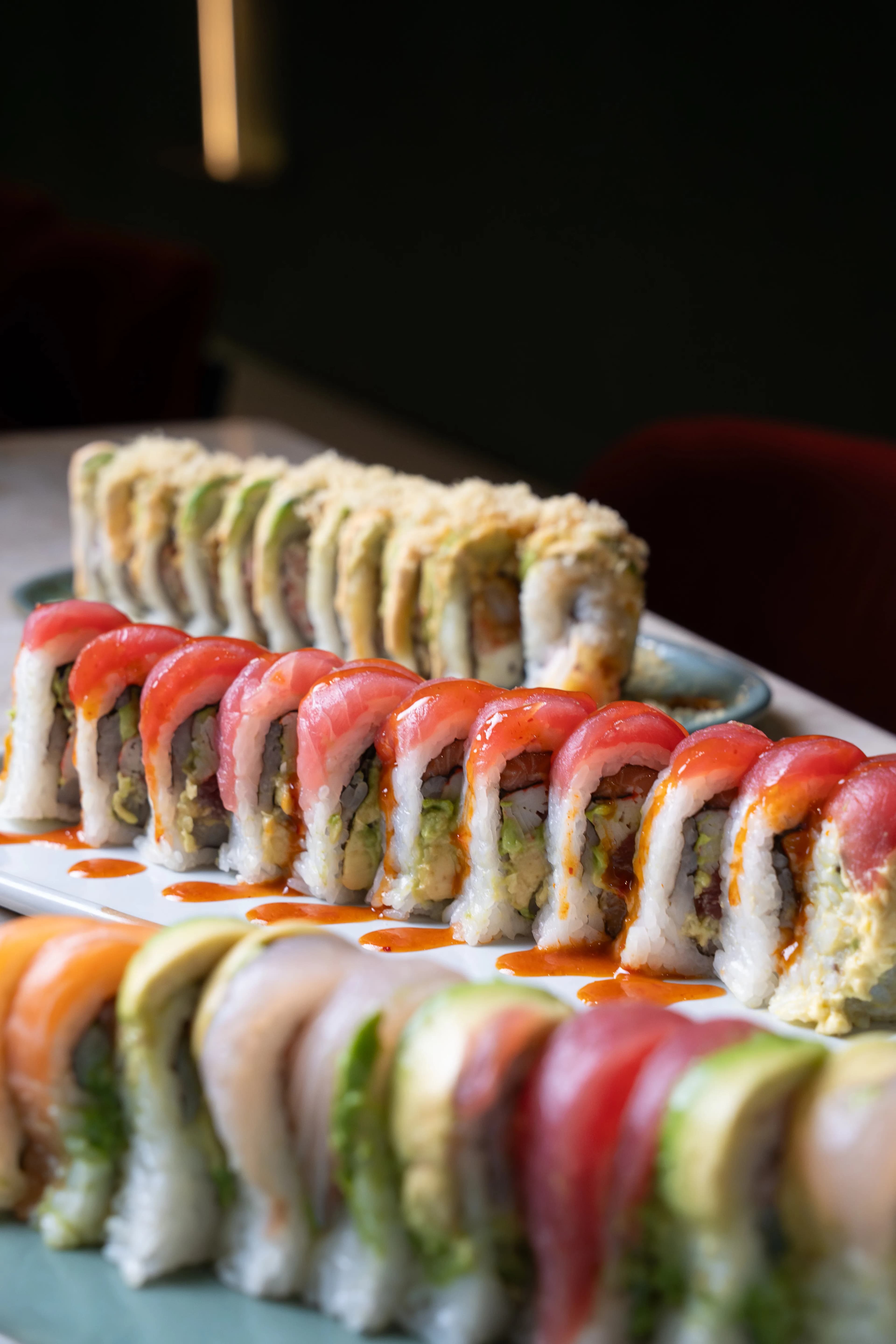 A plate of colorful Sushi Sake specialty rolls in warm light.